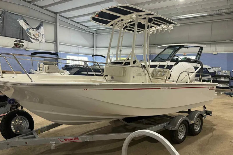 Slide: The Image of 2026 Boston Whaler 190 Montauk boat on trailer in showroom. - 5