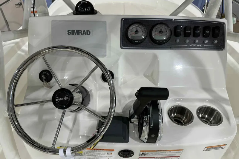 Slide: The Image of 2026 Boston Whaler 190 Montauk dashboard with steering wheel, gauges, and controls. - 7