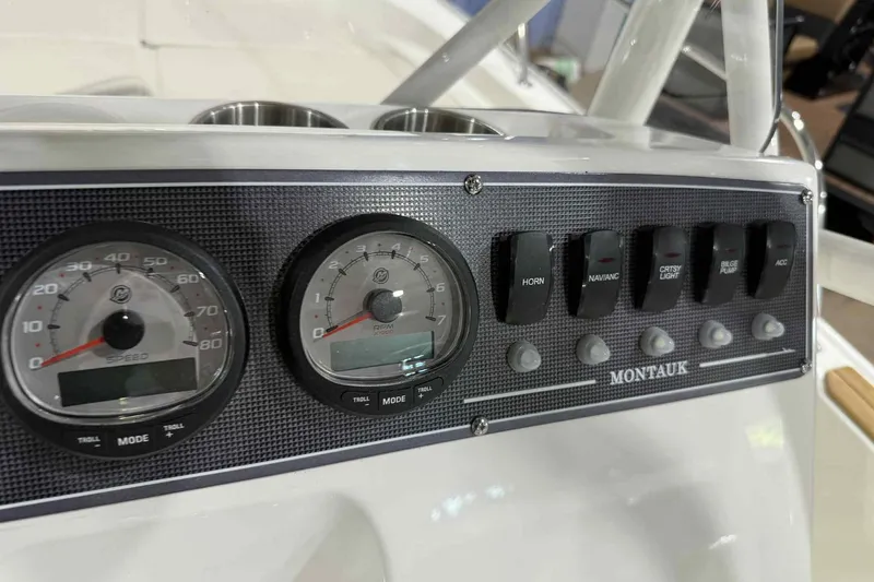Slide: The Image of 2026 Boston Whaler 190 Montauk dashboard with gauges and control switches. - 8