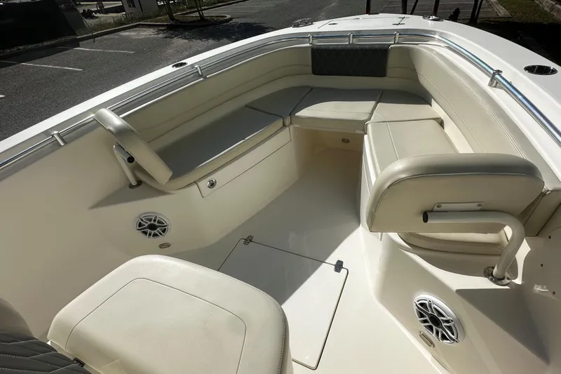 Slide: The Image of 2022 Cobia 262 Center Console boat interior with cushioned seating and speakers. - 12