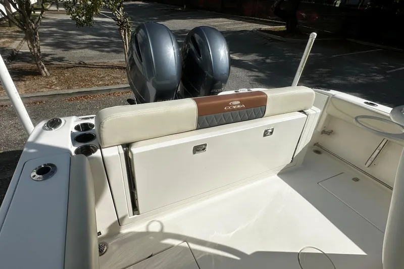 Slide: The Image of 2022 Cobia 262 Center Console boat with dual engines and spacious seating area. - 3