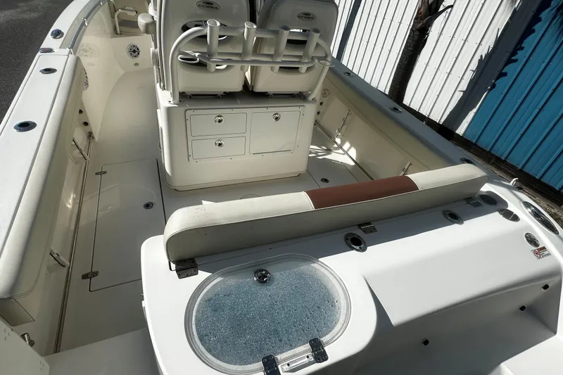 Slide: The Image of 2022 Cobia 262 Center Console boat interior with seating and storage compartments. - 8