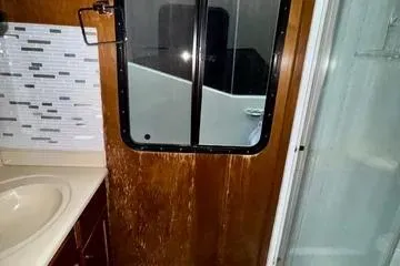 Slide: The Image of 2013 Bravada Bella Luna RV bathroom with sink, shower, and window. - 11