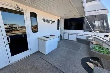 Slide: The Image of 2013 Bravada Bella Luna boat deck with door, storage box, and hose. - 16