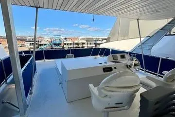 Slide: The Image of 2013 Bravada Bella Luna yacht deck with helm, overlooking marina and blue sky. - 17