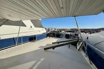 Slide: The Image of 2013 Bravada Bella Luna yacht deck with marina view under clear blue sky. - 19