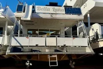 Slide: The Image of 2013 Bravada Bella Luna houseboat docked, rear view with slide and deck. - 22