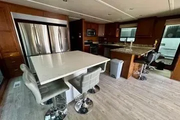 Slide: The Image of Modern kitchen interior in 2013 Bravada Bella Luna houseboat with sleek appliances and bar seating. - 5