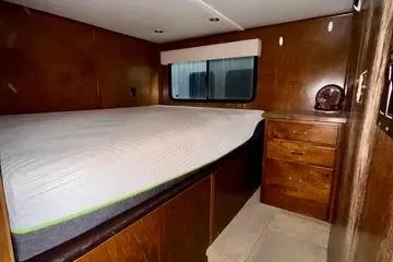 Slide: The Image of 2013 Bravada Bella Luna interior with bed, wooden cabinets, and window. - 8