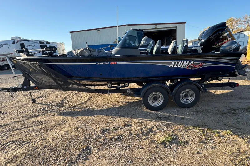Slide: The Image of 2017 Alumacraft Competitor 205 Sport boat on trailer, parked outdoors. - 0