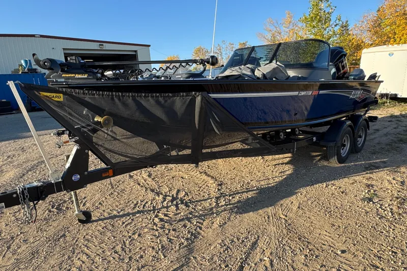 Slide: The Image of 2017 Alumacraft Competitor 205 Sport boat on trailer, parked outdoors. - 1