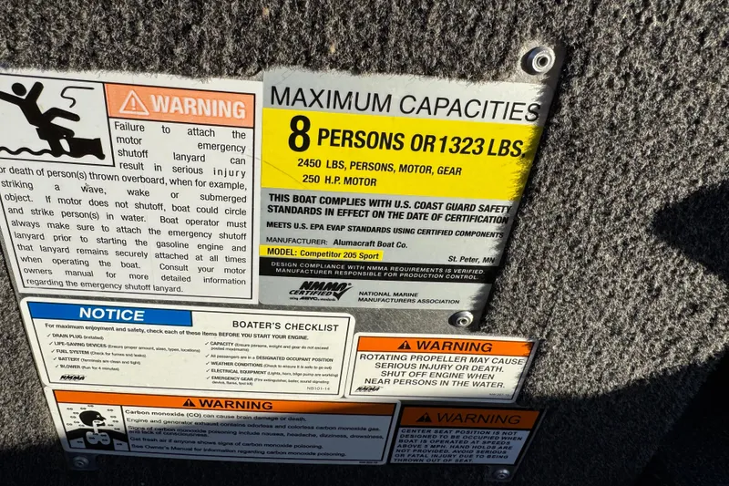 Slide: The Image of 2017 Alumacraft Competitor 205 Sport capacity warning labels, highlighting safety and maximum load limits. - 11