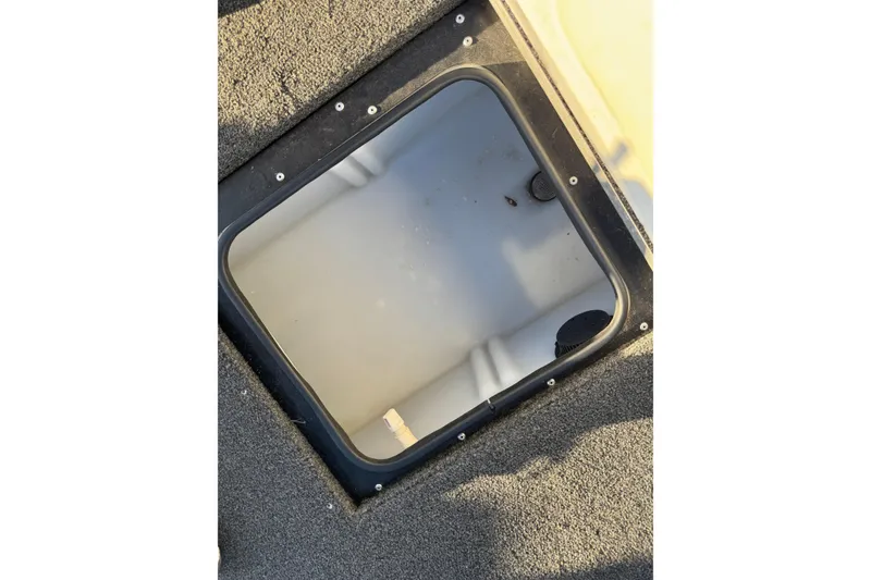 Slide: The Image of 2017 Alumacraft Competitor 205 Sport storage compartment with open hatch, showing interior details. - 22