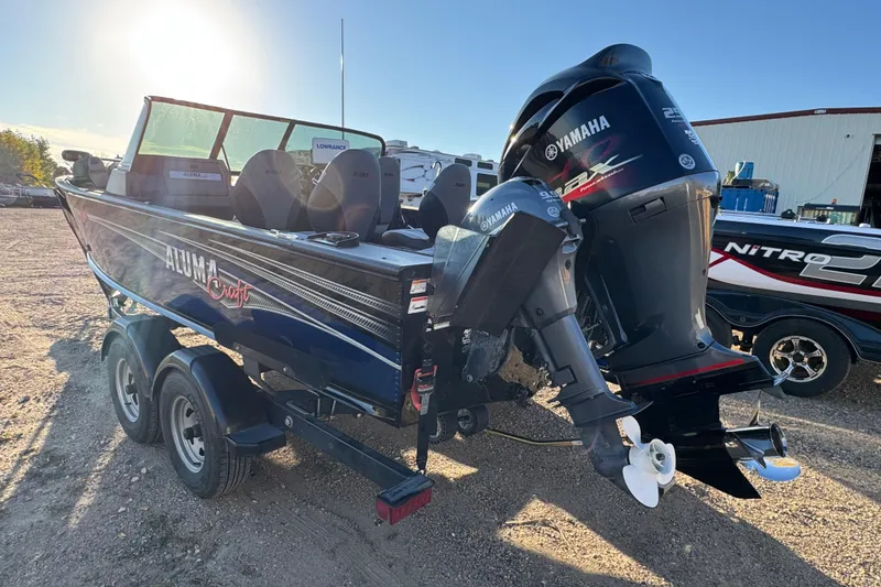 Slide: The Image of 2017 Alumacraft Competitor 205 Sport boat with Yamaha outboard motor in a sunny outdoor setting. - 5