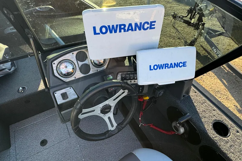 Slide: The Image of 2017 Alumacraft Competitor 205 Sport dashboard with Lowrance electronics and steering wheel. - 8