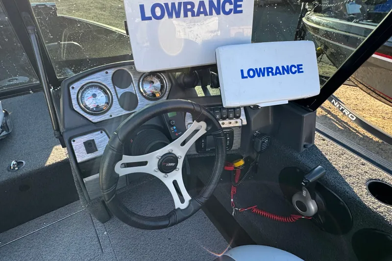 Slide: The Image of 2017 Alumacraft Competitor 205 Sport dashboard with Lowrance electronics and steering wheel. - 9