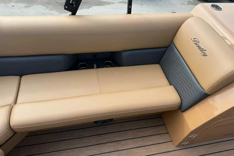 Slide: The Image of 2025 Bentley Pontoons Elite 253 Admiral, luxurious tan seating with Bentley logo. - 10