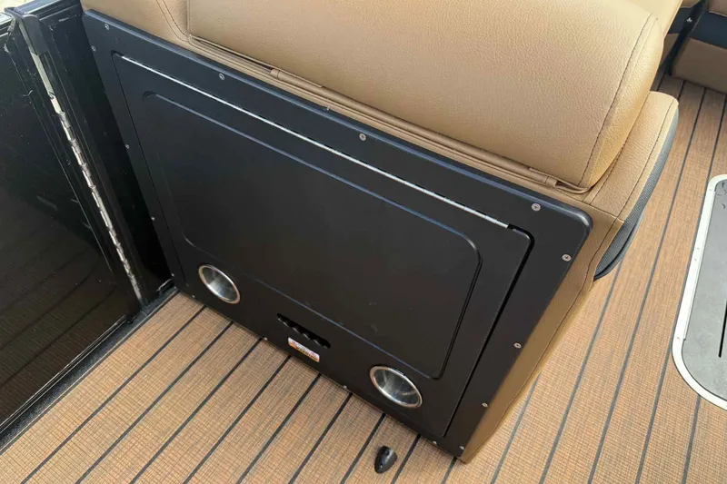 Slide: The Image of 2025 Bentley Pontoons Elite 253 Admiral interior detail with tan seating and black panel. - 13