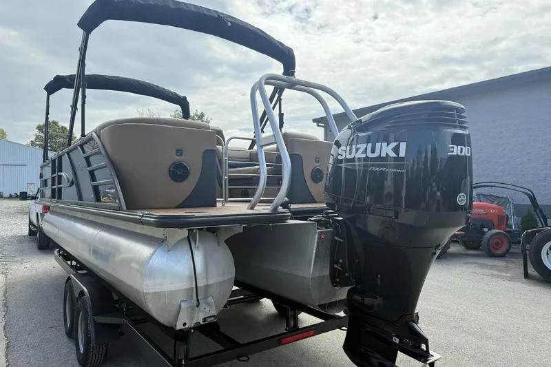 Slide: The Image of 2025 Bentley Pontoons Elite 253 Admiral with Suzuki 300 outboard motor on trailer. - 2