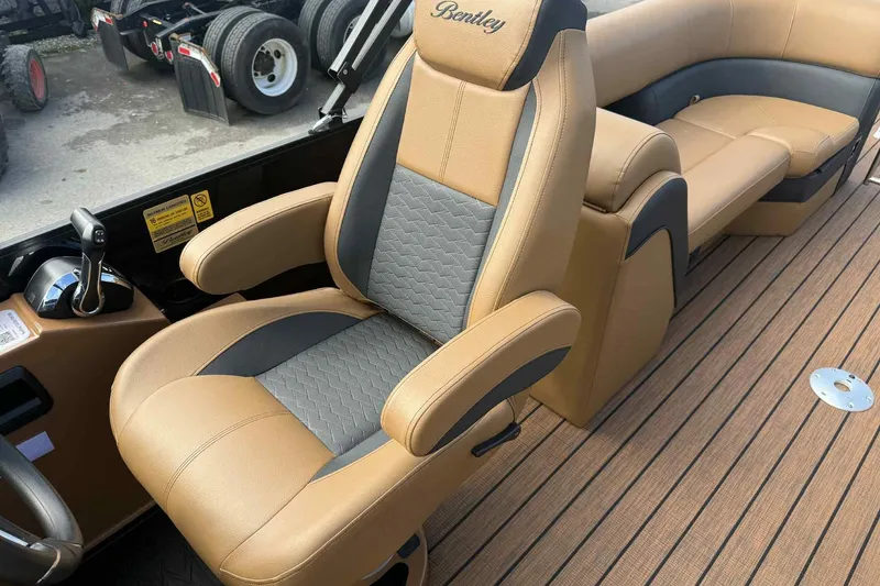 Slide: The Image of 2025 Bentley Pontoons Elite 253 Admiral interior with luxurious tan and gray seating. - 20