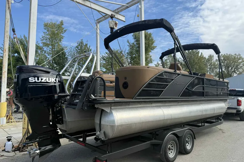Slide: The Image of 2025 Bentley Pontoons Elite 253 Admiral on trailer with Suzuki outboard motor. - 4