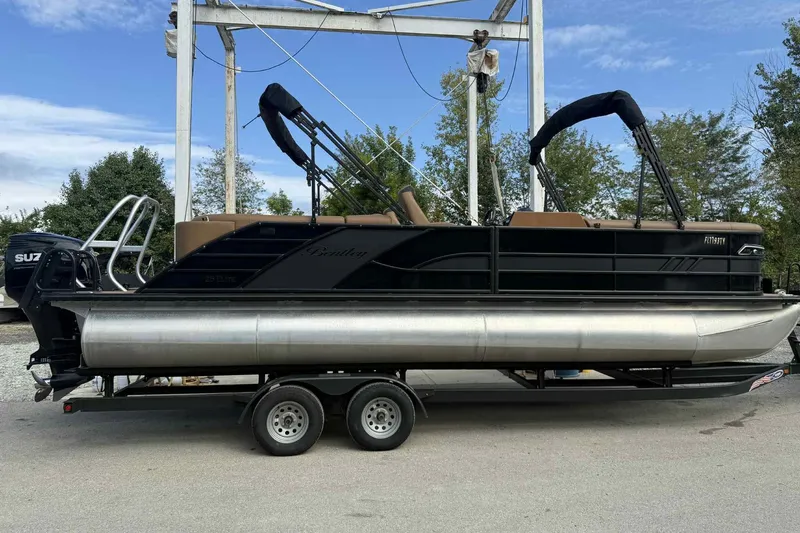 Slide: The Image of 2025 Bentley Pontoons Elite 253 Admiral on trailer, black exterior, parked outdoors. - 5