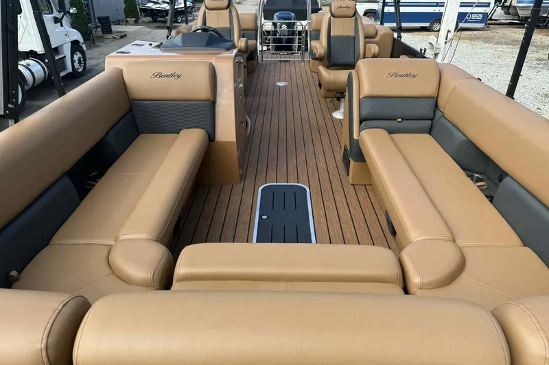 Slide: The Image of 2025 Bentley Pontoons Elite 253 Admiral interior with luxurious tan seating and wood flooring. - 8