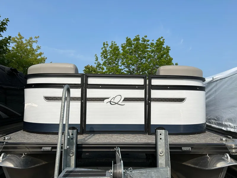 Slide: The Image of 2023 Qwest E 816 Lanai LT pontoon boat on trailer, under clear blue sky. - 2