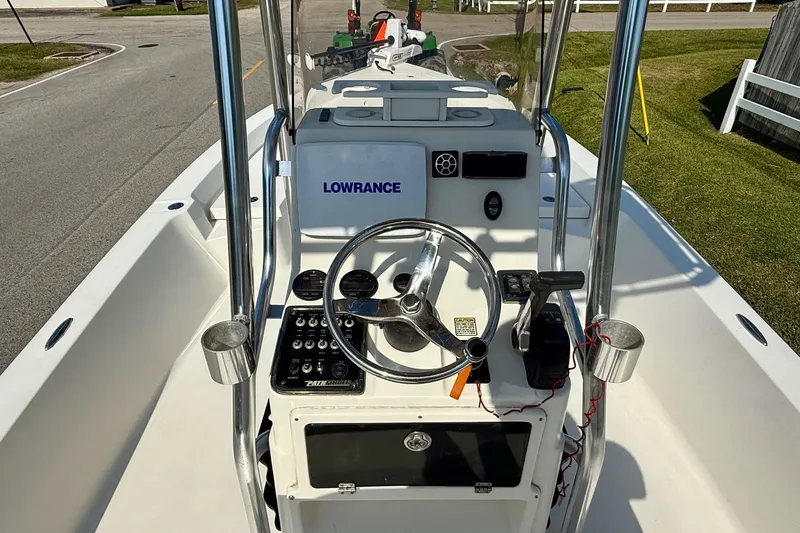 Slide: The Image of 2012 Pathfinder 2400 Tournament Edition boat console with steering wheel and controls. - 10