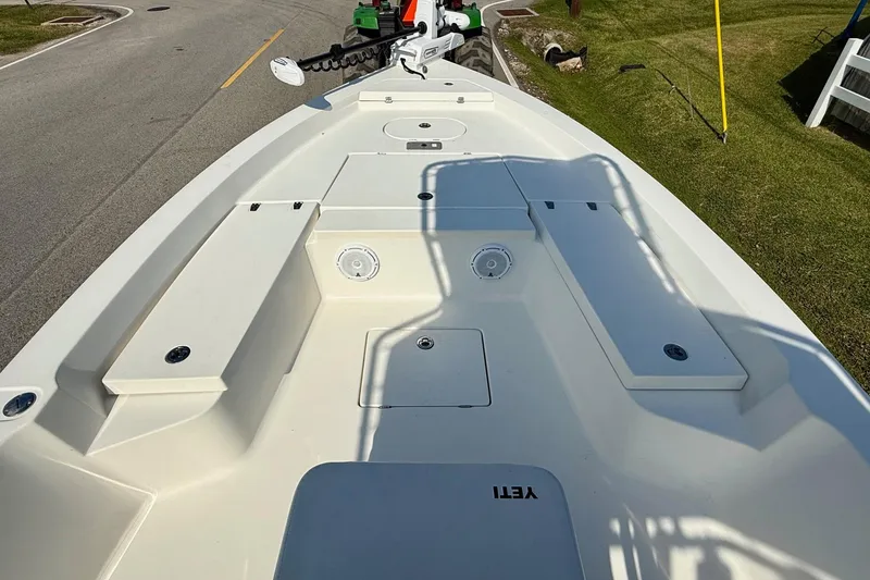 Slide: The Image of 2012 Pathfinder 2400 Tournament Edition boat deck with storage compartments and fishing rod holders. - 13
