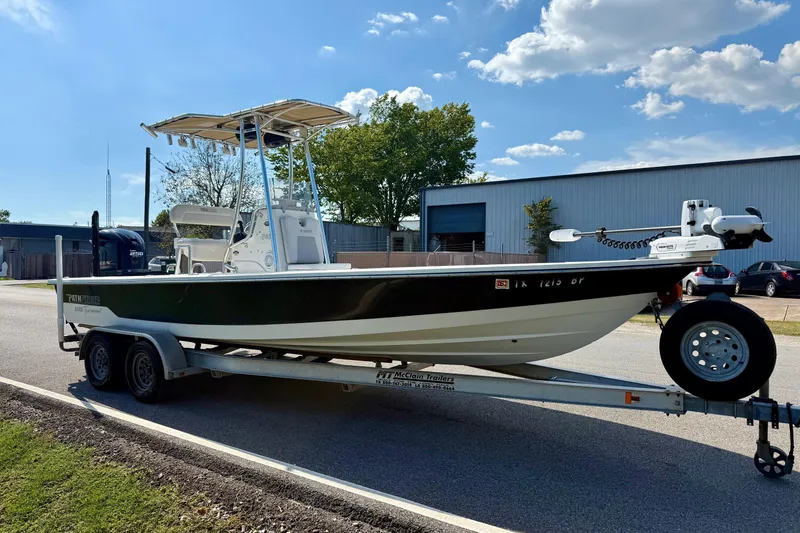 Slide: The Image of 2012 Pathfinder 2400 Tournament Edition boat on trailer, parked outdoors under blue sky. - 5