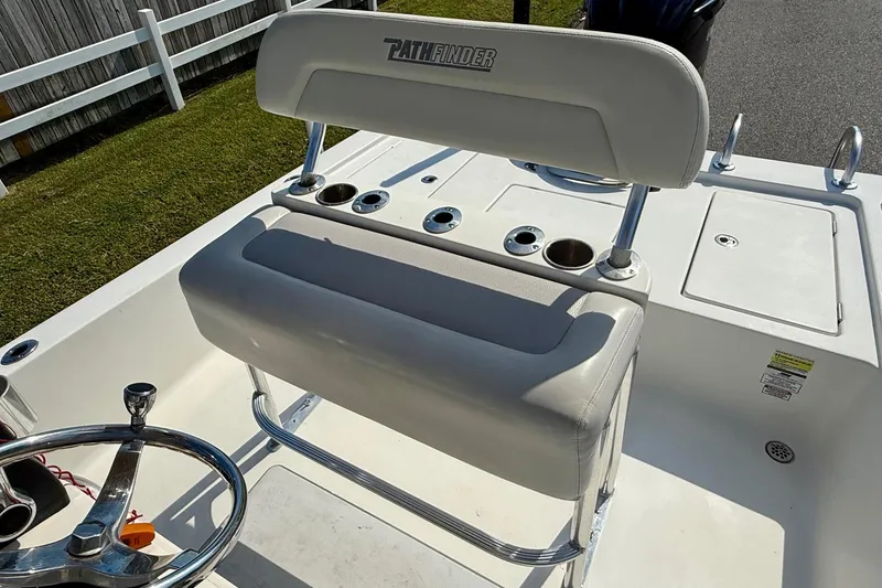 Slide: The Image of 2012 Pathfinder 2400 Tournament Edition boat interior with steering wheel and seating. - 9
