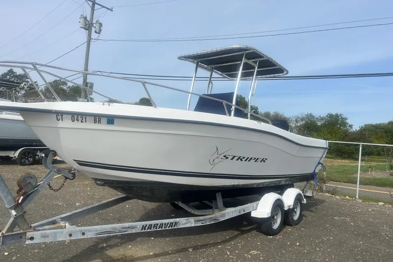 The Image of 2000 Seaswirl Striper 18.5 boat on trailer, parked outdoors. - 0