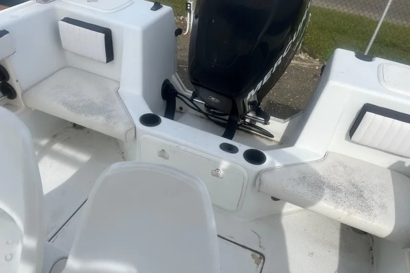 Slide: The Image of Interior of a 2000 Sea Swirl 18.5 boat with seating and Mercury engine. - 10