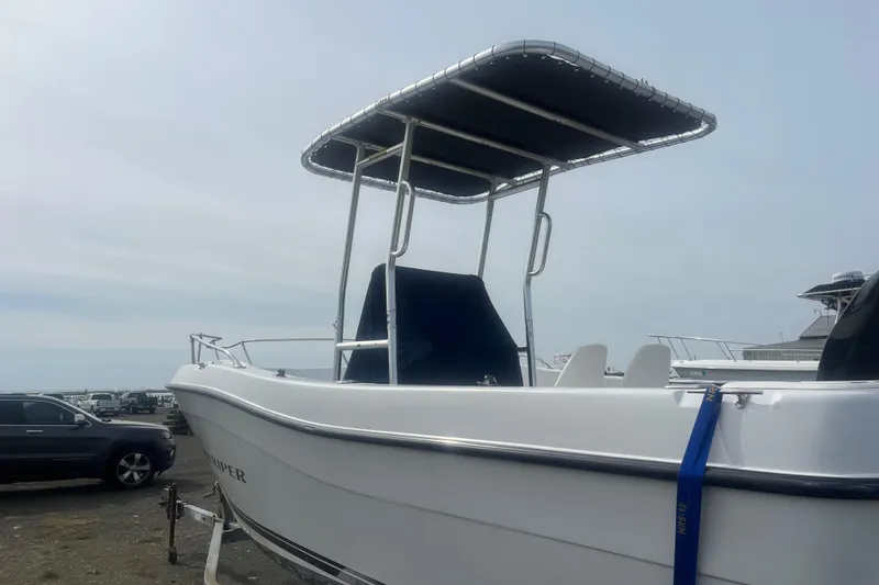Slide: The Image of 2000 Seaswirl Striper 18.5 boat with T-top, parked on a trailer. - 2