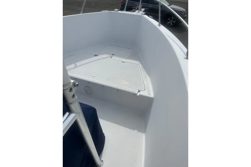 Slide: The Image of 2000 Sea Swirl 18.5 boat interior, featuring clean white deck and seating area. - 6