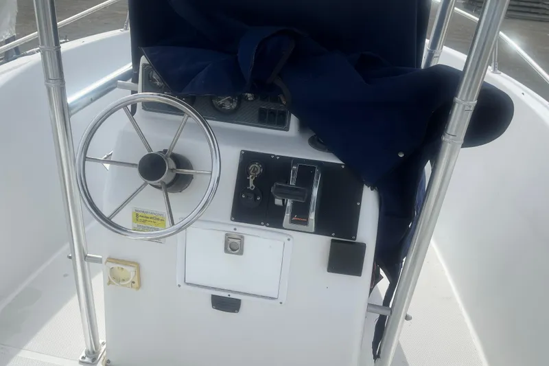 Slide: The Image of Steering console of a 2000 Sea Swirl 18.5 boat with controls and gauges. - 9
