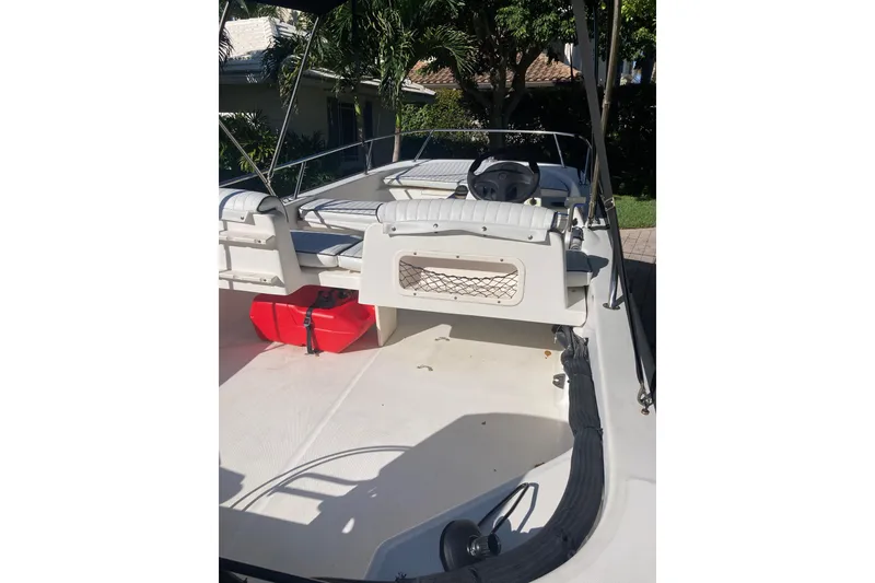 Slide: The Image of 2006 Boston Whaler 150 Sport boat interior with seating and steering wheel. - 14