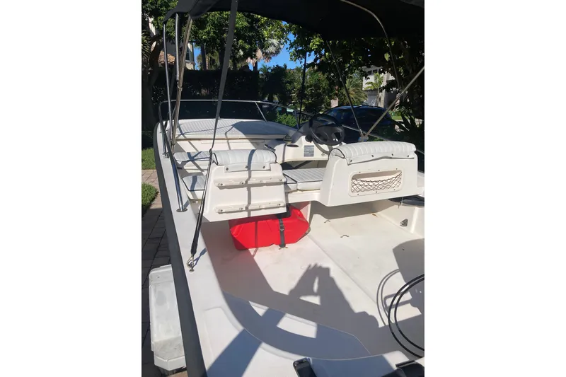 Slide: The Image of 2006 Boston Whaler 150 Sport boat interior with seating and steering wheel. - 15