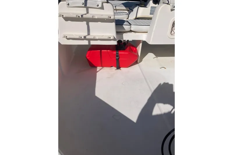 Slide: The Image of Interior of a 2006 Boston Whaler 150 Sport boat with red fuel tank. - 16