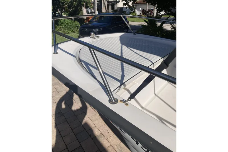 Slide: The Image of 2006 Boston Whaler 150 Sport boat with stainless steel railings and white deck. - 9