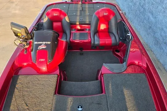 Slide: The Image of 2011 Ranger Z120 Comanche boat interior with red and black seating and dashboard. - 10