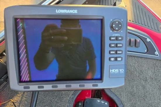 Slide: The Image of 2011 Ranger Z120 Comanche boat interior with steering wheel and dashboard in sunlight. - 9