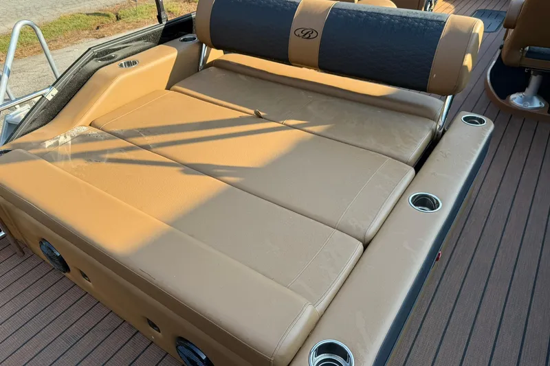 Slide: The Image of 2025 Bentley Pontoons Elite 253 Swingback with tan leather seating and cup holders. - 10