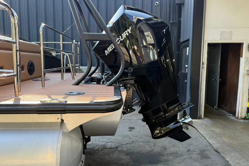 Slide: The Image of 2025 Bentley Pontoons Elite 253 Swingback with Mercury outboard motor, docked in a marina. - 12