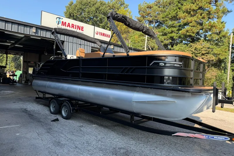 Slide: The Image of 2025 Bentley Pontoons Elite 253 Swingback on trailer at marine dealership. - 3