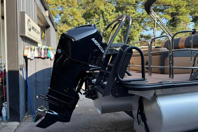 Slide: The Image of 2025 Bentley Pontoons Elite 253 Swingback with Mercury outboard motor at service center. - 5