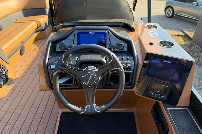 Slide: The Image of 2025 Bentley Pontoons Elite 253 Swingback dashboard with steering wheel and navigation screens. - 7