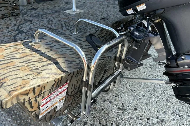 Slide: The Image of 2026 Xpress H20B Bay boat with camouflage design and stainless steel ladder. - 11