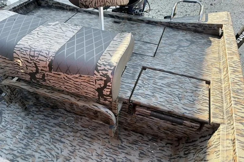 Slide: The Image of 2026 Xpress H20B Bay boat interior with camouflage seating and deck design. - 16